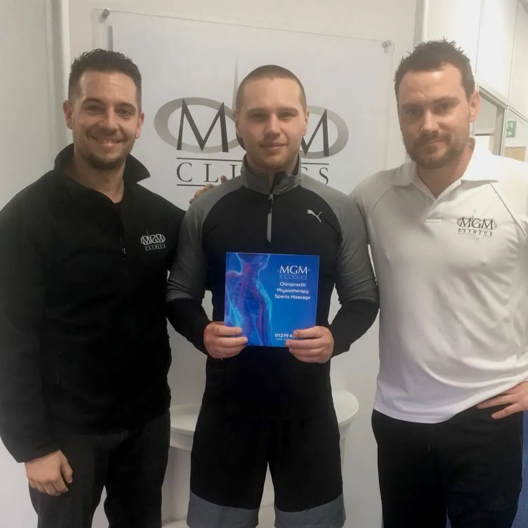 MGM Clinics team holding a certificate