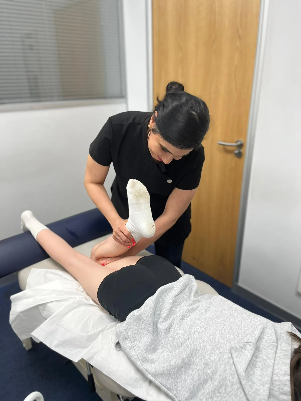 Physiotherapist working on a patient's lower leg