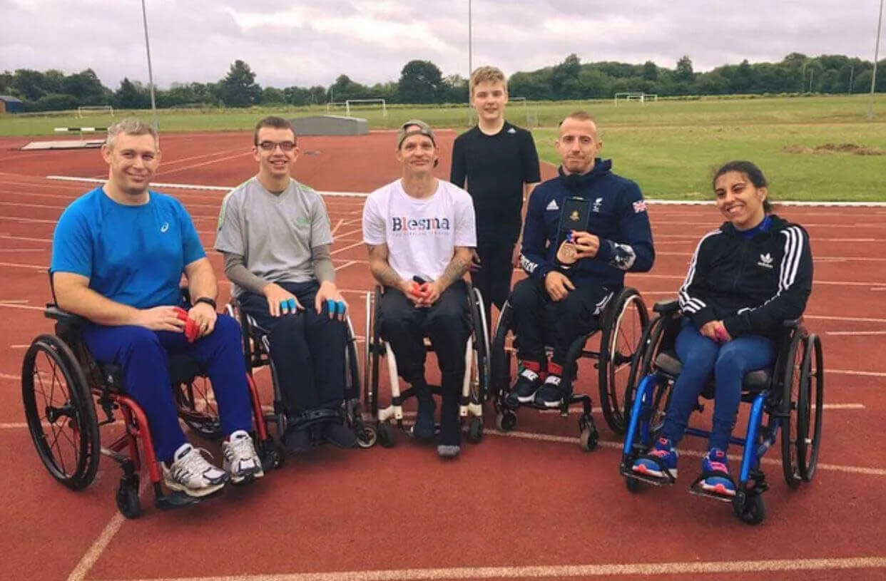 MGM Clinics team with wheelchair athletes at an athletics track